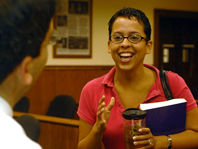 Smiling student carrying book