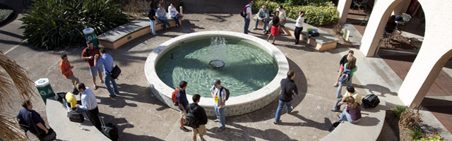 students in Crummer Courtyard walk by fountain
