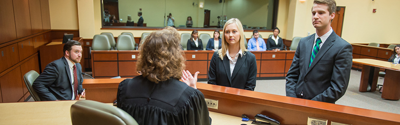 students deliberating in courtroom