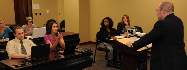 Students sitting at a table in the Dolly and Homer Law Library