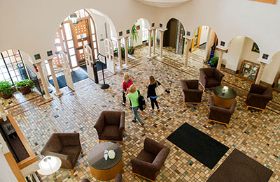 students walk in lobby of library