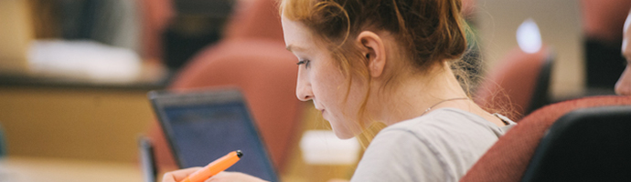 woman highlighting her notes