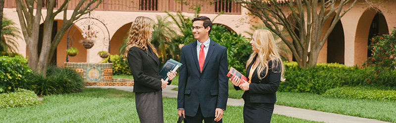 three students in the plaza mayor courtyard