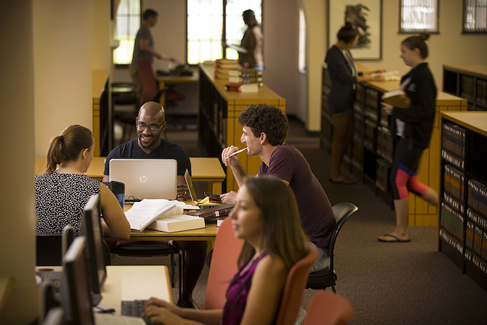 Students sitting at a table in the Dolly and Homer Law Library