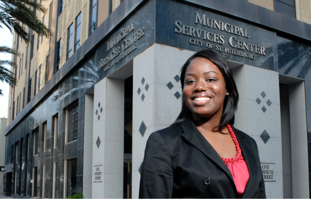 Female student stands outside of Municipal Services Center in downtown St. Petersburg, FL