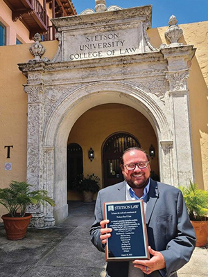 Professor Peter Lake holding award