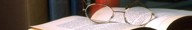 glasses on top of open book