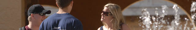 Students talk near Crummer Courtyard fountain on Gulfport campus.