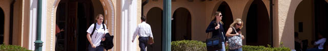 Students walk near main entrance of law library on Gulfport campus.