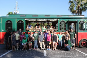 The Stetson Law volunteers take a break for a photo with the trolley and Fun in the Sun in Gulfport. Photo by Brittany Brochard.