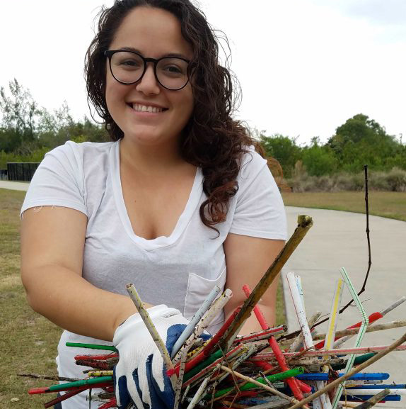 Jennifer Winn with plastic straws retrieved during a local cleanup. Photo courtesy Vanessa Moore.