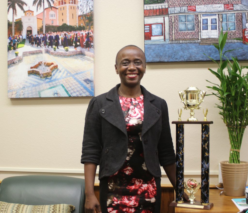 Dean Michele Alexandre with Stetson's trophy for most clinic participation in Florida Bar Foundation pro bono challenge.