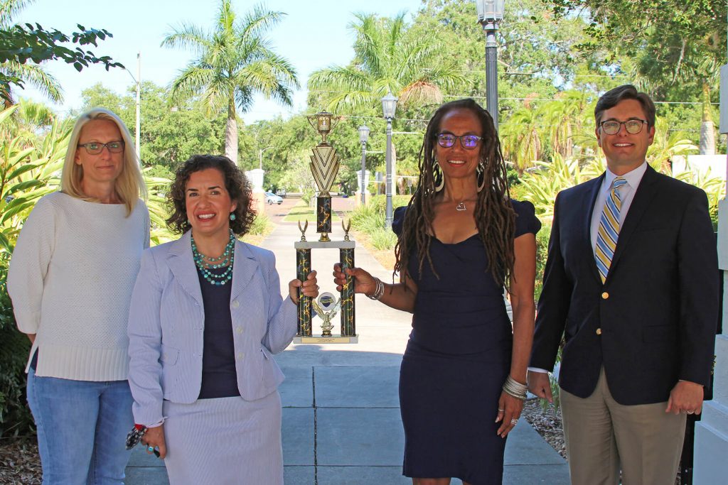 Stacy Elizondo, Career and Professional Development coordinator; Associate Professor Christine Cerniglia, director of Clinical and Experiential Education; Professor Judith Scully, co-founder of the Stetson Social Justice Advocacy Program and current chair of the Pro Bono Committee; and Mike Casey, associate director of Alumni Relations with the 2021 Florida Pro Bono Law School Challenge trophy.