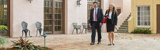 Two College of Law students walking across courtyard