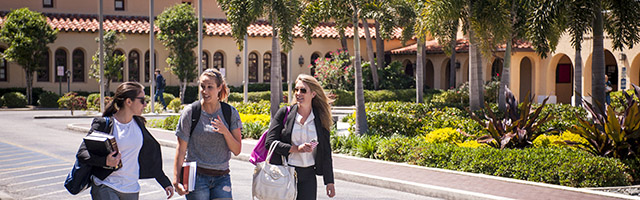 three students walk in Sebring Commons area on Gulfport campus