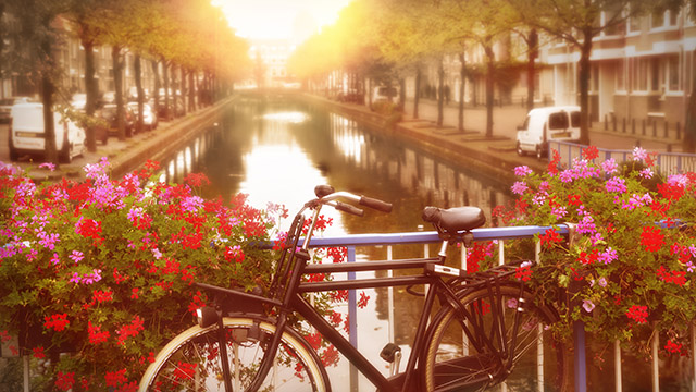 A bicycle on a bridge over a canal.