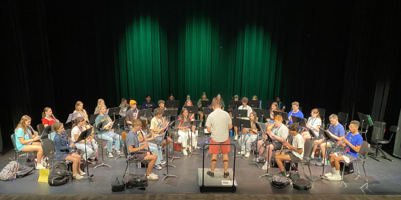 group of students practicing clarinet with conductor