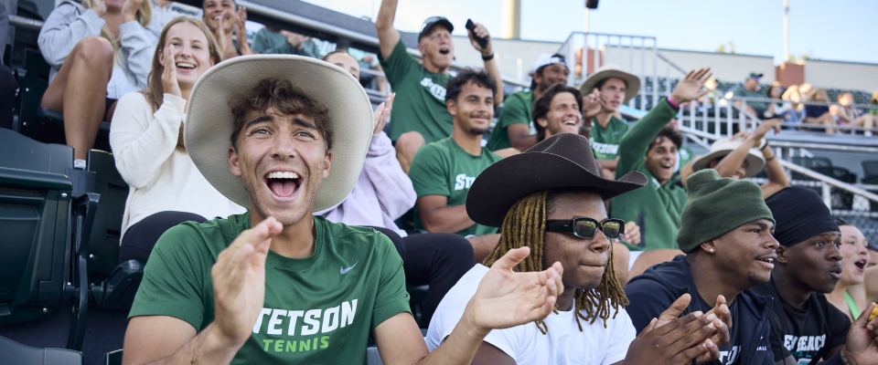 students cheering for athletics team