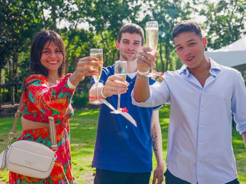 students raising their glasses for a toast with the president during senior toast