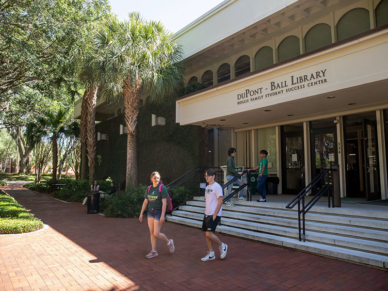 two students leaving the duPont-Ball Library