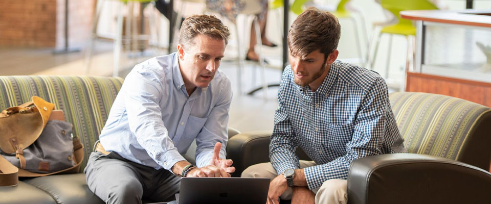 Entrepreneurship professor working with student.