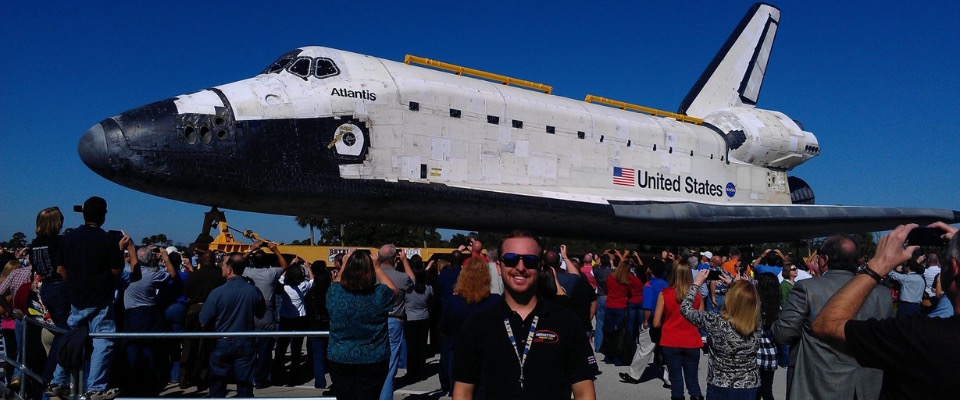 a crowd of spectators, admiring the weathered Space Shuttle Atlantis