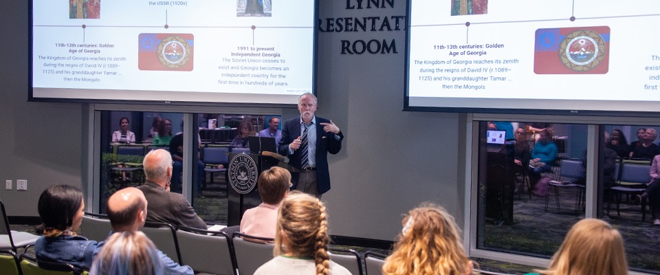 Professor lecturing class in Lynn Presentation Room