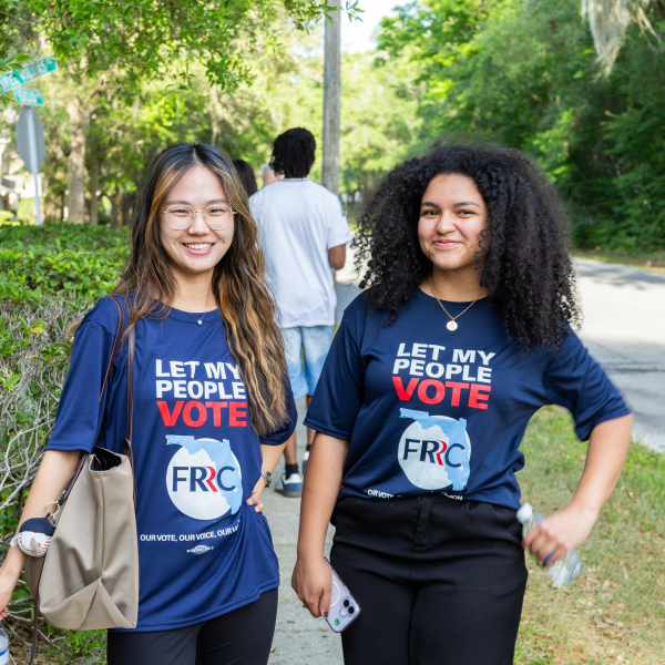 two students with voting shirts