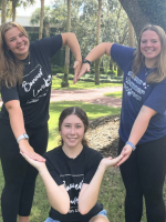 Three students forming Bonner Love heart logo