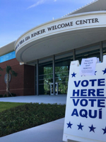 A sandwich board instructing students to Vote Here