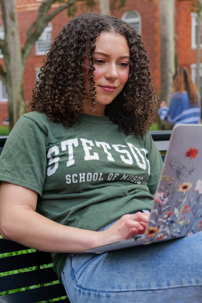 student looking at laptop online