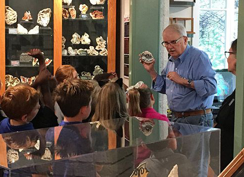 Agatized coral and agatized coral rock geode specimens; Sam Upchurch talking Agatized Coral with elementary school students at Gillespie