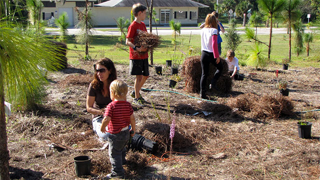 Children and adults engaging in gardening activities