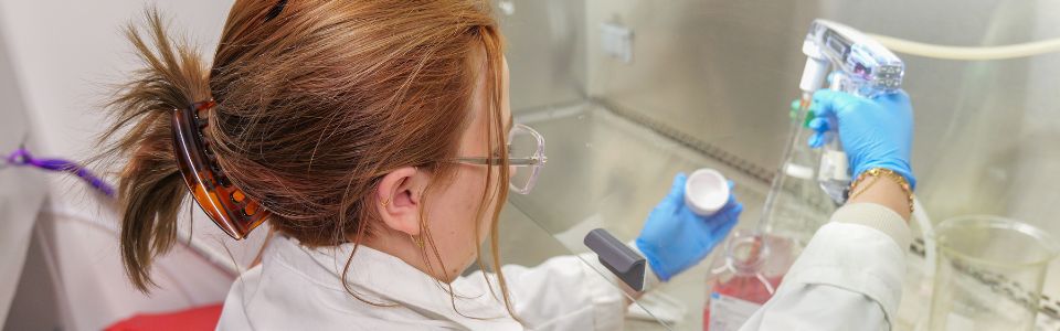 student using microscope on lab