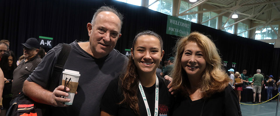 Family posing for the camera on during an orientation