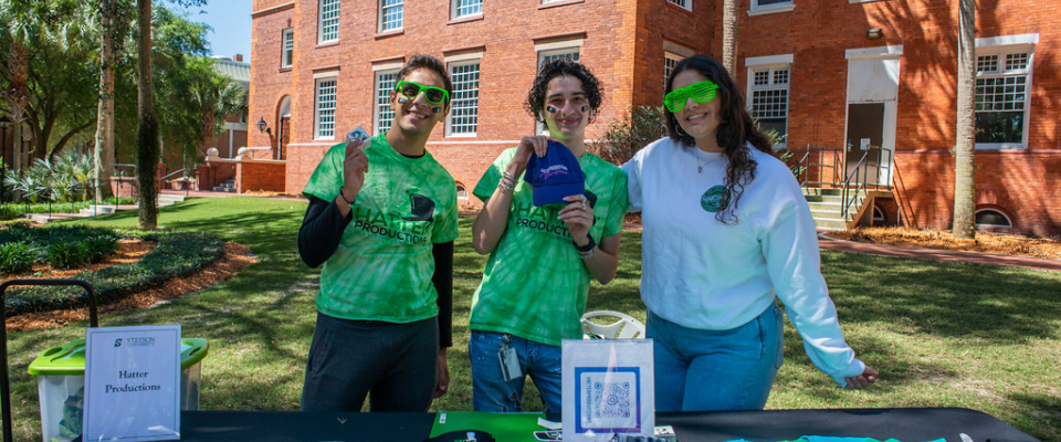 Students wearing Stetson shirts smiling and posing for camera