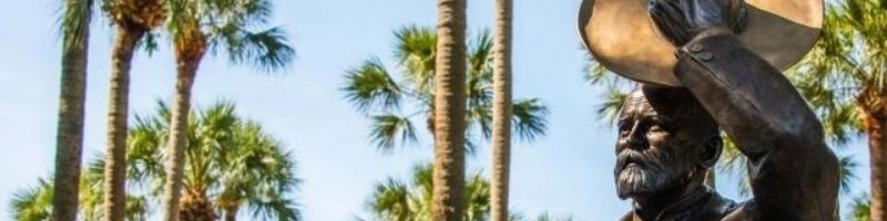 John B. Statue with Palm Trees