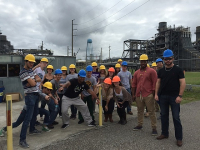 group of students and faculty at a construction site