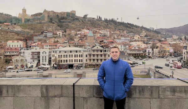 student taking a picture in front of city during study abroad