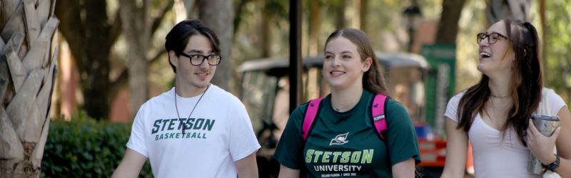 students walking outside smiling