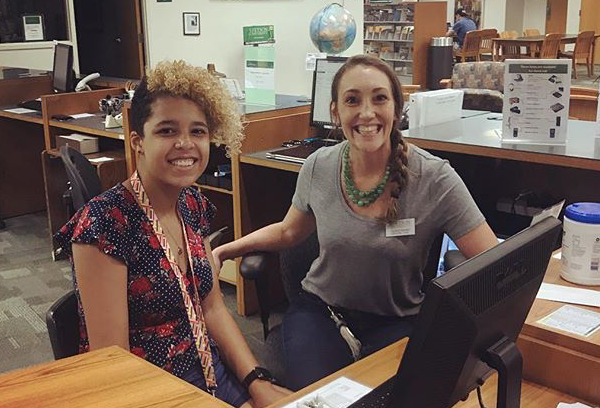 Two students at the front desk.