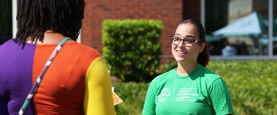 student from WORLD talking with other students