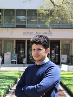 Yahia Adla standing and smiling outside duPont Ball Library