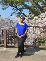 Anuket Goins in front of a natural landscape