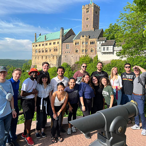 Stetson University music students touring in Europe Posing in front of a castle