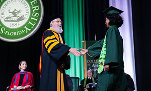student walking the graduation stage