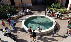 An aerial view of students walking by the south fountain of the Gulfport campus