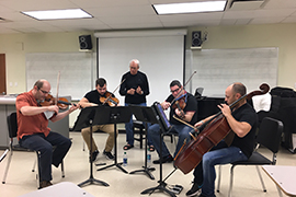 The Amernet String Quartet practices Monday with Sydney Hodkinson, Stetson adjunct professor of Music and a composer.