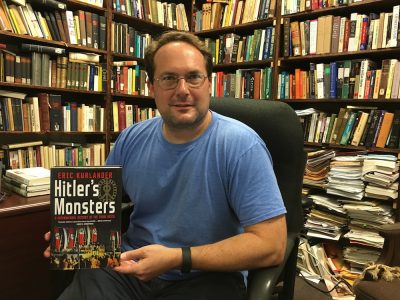 Stetson History Professor Eric Kurlander holds his book in his office.