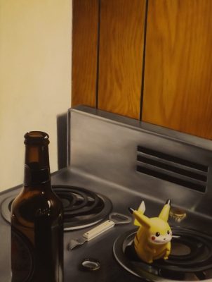 A photo of a stovetop with a glass bottle, pokemon and wooden cabniets.